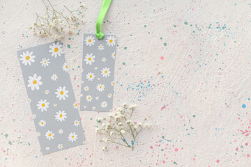 Bookmarks and flowers on light background