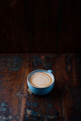 Coffee with milk on dark wooden background. Copy space.