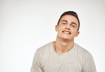 Cheerful handsome man gray t-shirt lifestyle cropped view