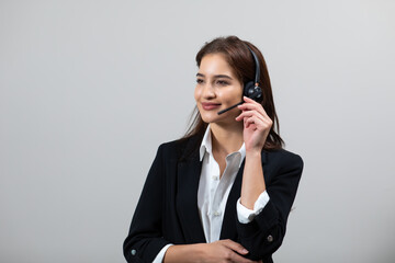 Attractive business woman in suits and headsets are smiling while working isolate on white background. Customer service assistant working in office. VOIP Helpdesk headset
