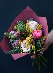 Beautiful bouquet of roses, carnation, hippeastrum, carnation, Mimosa. bouquet close up.  Fresh spring bouquet.