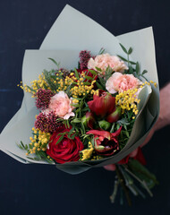 Beautiful bouquet of roses, carnation, hippeastrum, carnation, Mimosa. bouquet close up.  Fresh spring bouquet.
