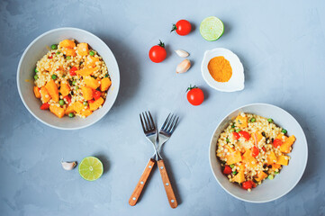 homemade ptitim pasta cooked in arabian style with curry, pumpkin and fresh cerry tomatoes