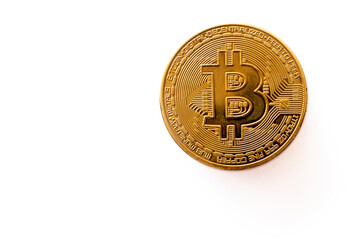 Close-up of gold Bitcoin coins on white background.