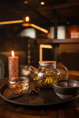 Tea brewing process, tea ceremony, freshly brewed green tea cup, warm soft light, dark background.
