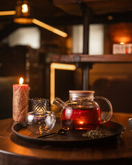 Obraz na płótnie Canvas Tea brewing process, tea ceremony, freshly brewed red tea cup, warm soft light, dark background.