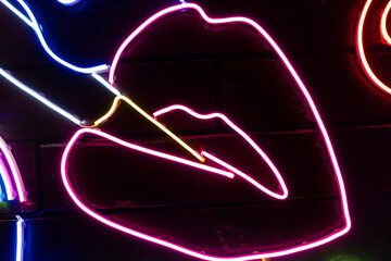 Neon assorted shapes on a black wall. Glowing multi-colored neon.