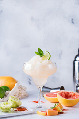 Frozen Mezcal or mescal Margarita cocktail with grapefruit and lime