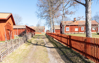 Front of a red wooden farmhouse painted in a traditional swedish color.
