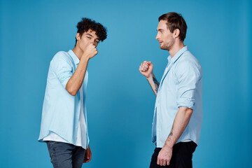 curly-haired guy in a shirt greets his friend on a blue background