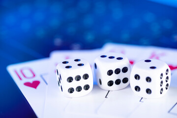 Online gaming platform, casino and gambling business. Cards, dice on laptop keyboard