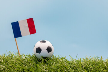 Soccer ball with flag of France on blue sky background