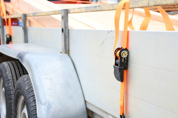 Trailer strop or strap in orange nylon and metal, object helping for holding stuff , storage and...