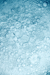 Abstract background with oil droplets on water surface blue