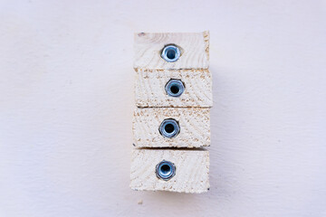 Close-up of wooden cubes with a nut inside on a light beige background