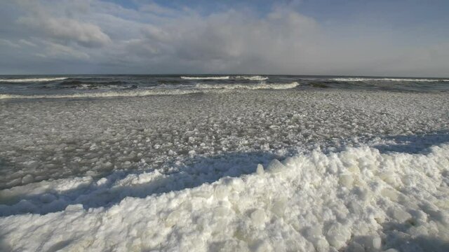 Ice floes and Icebergs on Frozen Baltic Sea in Poland on Sunny Day