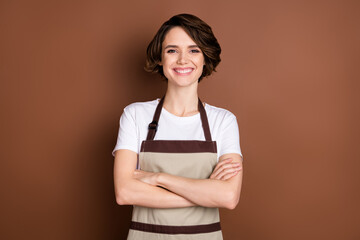Portrait of attractive content cheerful girl barista coffee shop service folded arms isolated over...