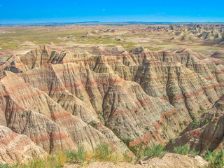 Hay Butte Overlook at Badlands National Park, United States. Eroded rugged peaks in a sunny day with blue sky. Popular american travel destination in South dakota.