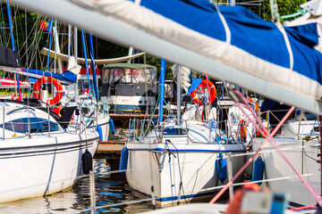 Yachts moored in a harbor. Sailboats in the dock. Summer vacations, cruise, recreation, sport, regatta, leisure activity, service, tourism