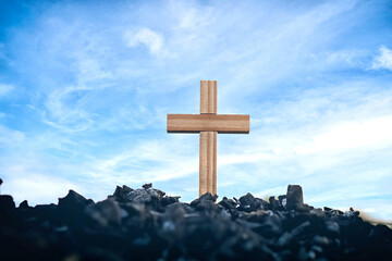 Wooden cross standing on charcoal, Jesus cross, Easter, resurrection concept, symbol of sacrifice,...