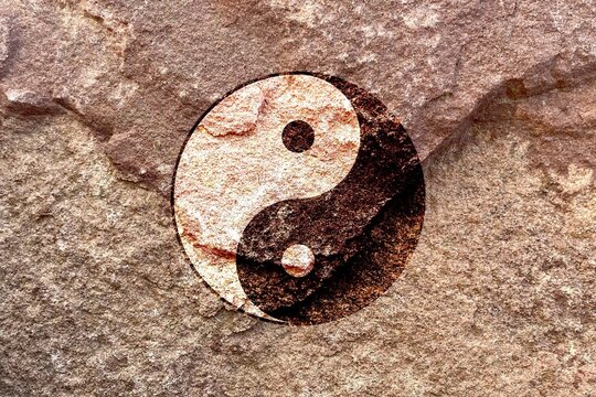 Taoism Tai Chi Yin Yang sign on solid stone wall background, abstract oriental Tao Taoism religion culture philosophy concept, Chinese taiji symbol art