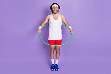 Full size photo of young crazy funky funny smiling man in glasses hold hula hoop isolated on purple color background - obrazy, fototapety, plakaty