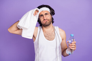 Photo of young tired exhausted handsome athlete man drinking water wipe forehead with towel...