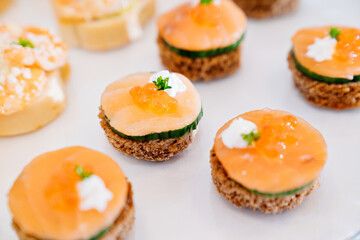 canapes. A convenient buffet feed. little sandwiches at the festival. Catering. delivery of ready meals and service of banquets.