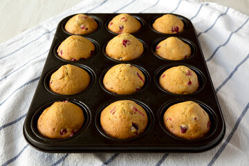 Homemade Cranberry Muffins with Orange Zest in a baking pan, low angle view.