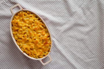 Homemade Macaroni and Cheese Pasta on cloth, top view. Flat lay, overhead, from above. Space for text.