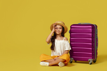little girl with suitcase and passport sitting on floor