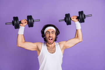 Naklejka na ściany i meble Photo of crazy sportsman raise hands hold dumbbells open mouth wear glasses singlet isolated purple background