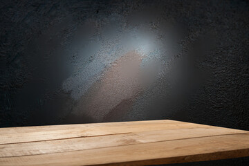 Selected focus empty brown wooden table and wall texture or old black brick wall blur background...