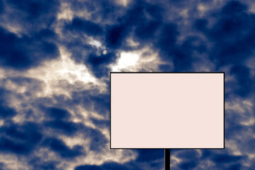 Blank billboard against a stormy sky. Alarming, dangerous news.