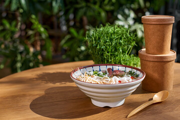 Cardboard containers for food, drinks, items. Vietnamese soup FO BO in a bowl