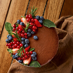 Chocolate cake from chocolate pancakes with icing, with blueberries. selective focus.