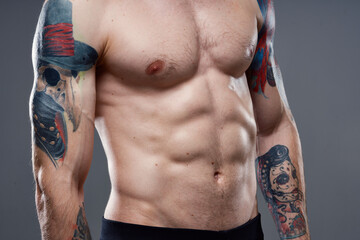 Naklejka premium man with pumped up press tattoo on his arms cropped view of workout