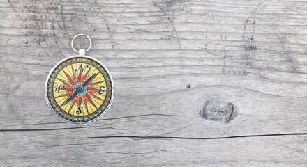 round compass on natural wooden background as symbol of tourism with compass, travel with compass...