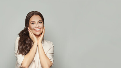 Fototapeta premium Beautiful young woman smiling on gray banner background portrait