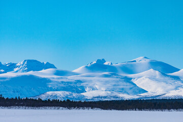 Nikkaluokta, Sweden Mountains in the Arctic landscape and blue sky.