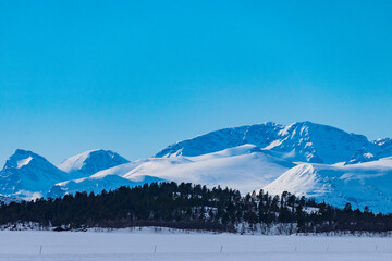 Nikkaluokta, Sweden Mountains in the Arctic landscape and blue sky.