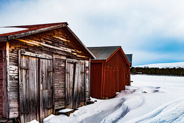 Nikkaluokta, Sweden Small wooden cabins in the Arctic landscape.