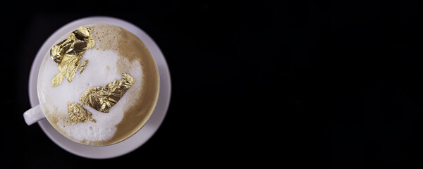 Cup of cappuccino with a golden foam, luxury morning drink concept - 427601918