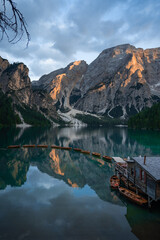 Lake Braies (Lago di Braies) in Dolomites Mountains, Boat hut on Braies Lake with Seekofel mount on background, Sunrise of Italian Alps, Naturepark Fanes-Sennes-Prags, Dolomite, Italy, Europe.
