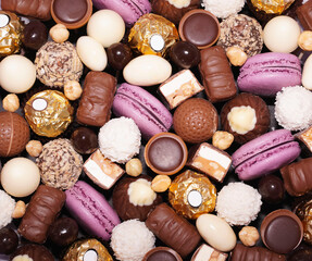Assortment of chocolate colourful, festive sweets candy macaroons and nuts. Sweet candy background. mix of chocolate candies, top view.