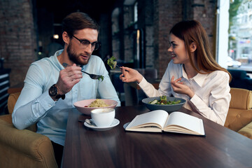 young couple in a cafe at the breakfast table communication lifestyle