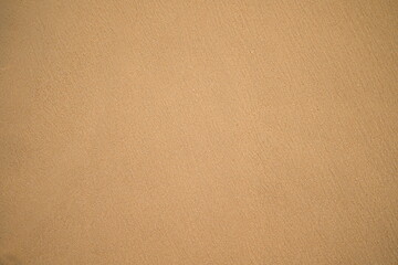 Natural brown sand background, surface and texture.
