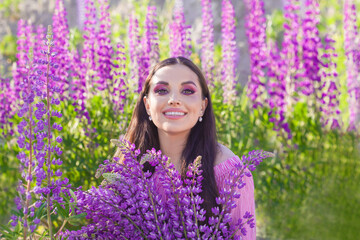 Happy summer woman with colorful flowers smiling outdoors