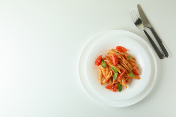 Plate with pasta with tomato sauce on white background