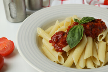 Concept of tasty food with pasta with tomato sauce on white background